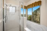 Master bathroom features a step in shower, jacuzzi tub, and double sink counter top. What views for nice soak in the tub